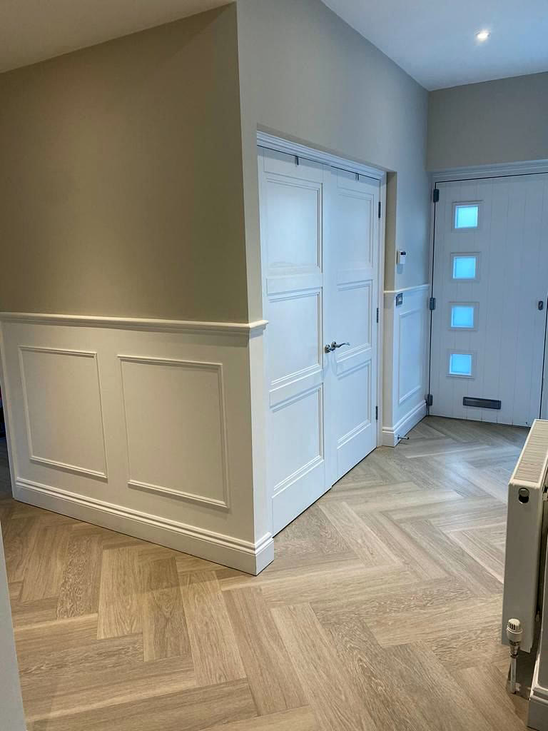 Entrance hall with panelling and herringbone parquet