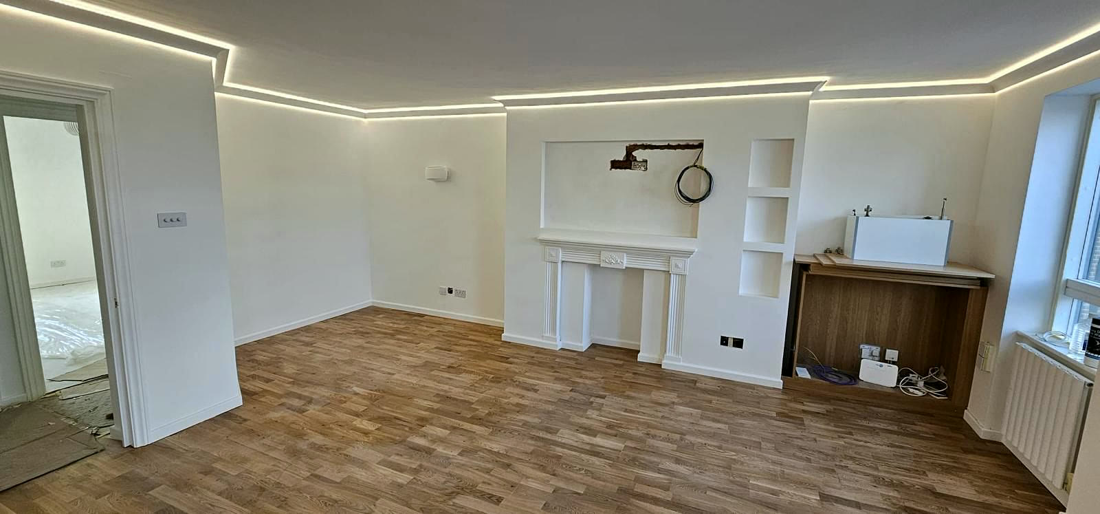 Living room with LED coving and built-in niches