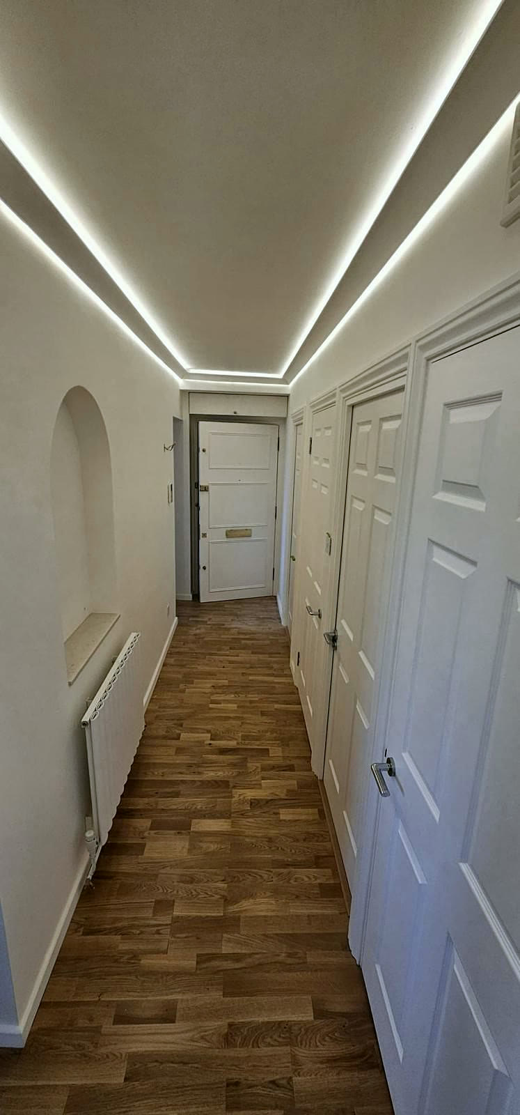Corridor with LED cove lighting and new doors