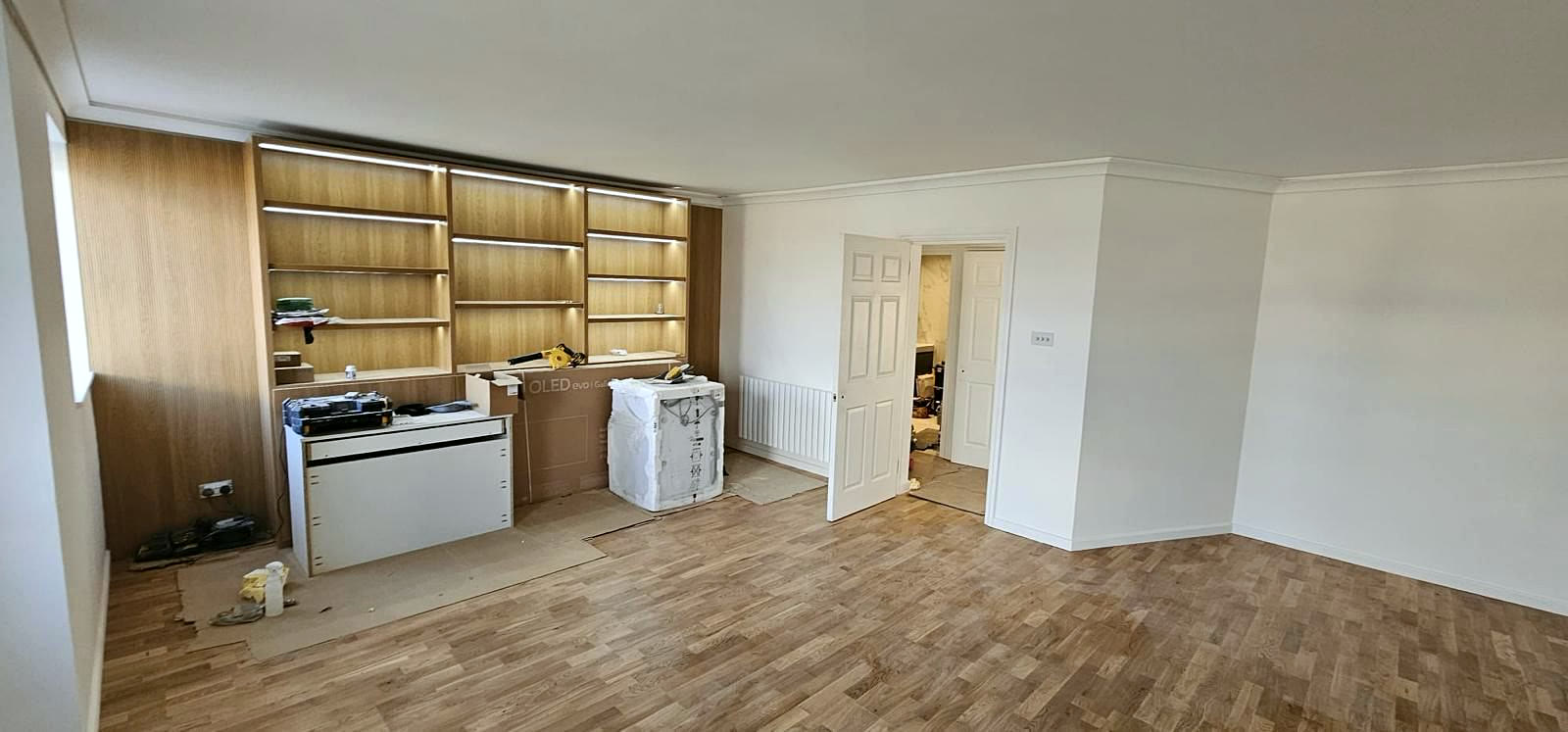 Open-plan room with built-in shelving in progress