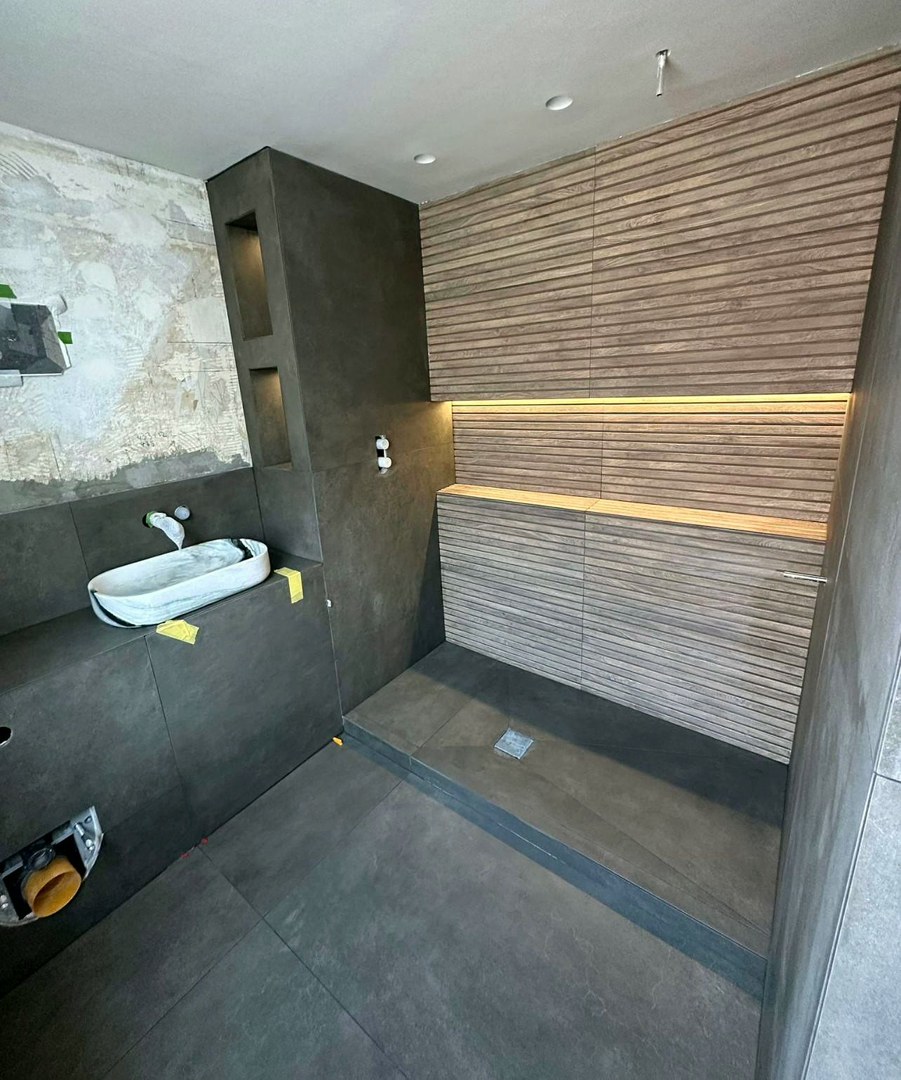 Shower room with timber-slat feature wall and LED shelf