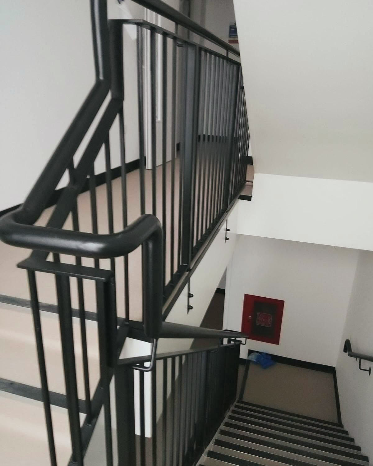 Renovated communal staircase with black railings